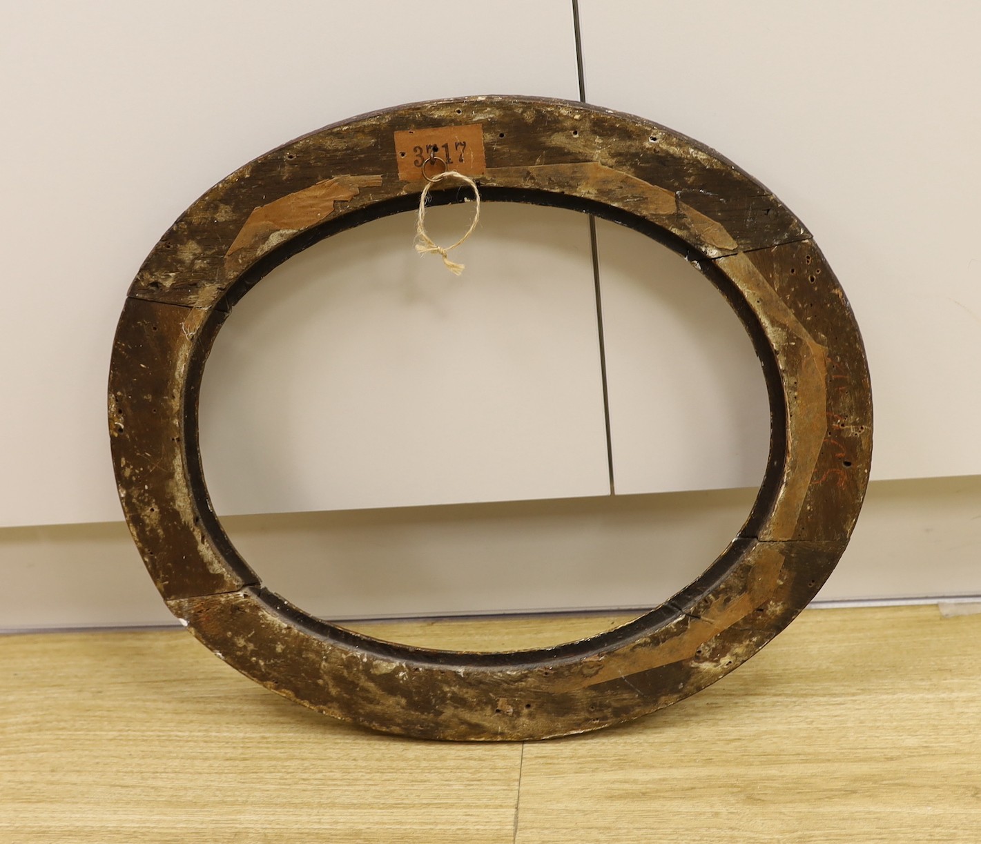 An 18th century hand carved gilt gesso oval frame, 52 cms high